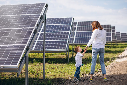 mother with her little son by solar panels